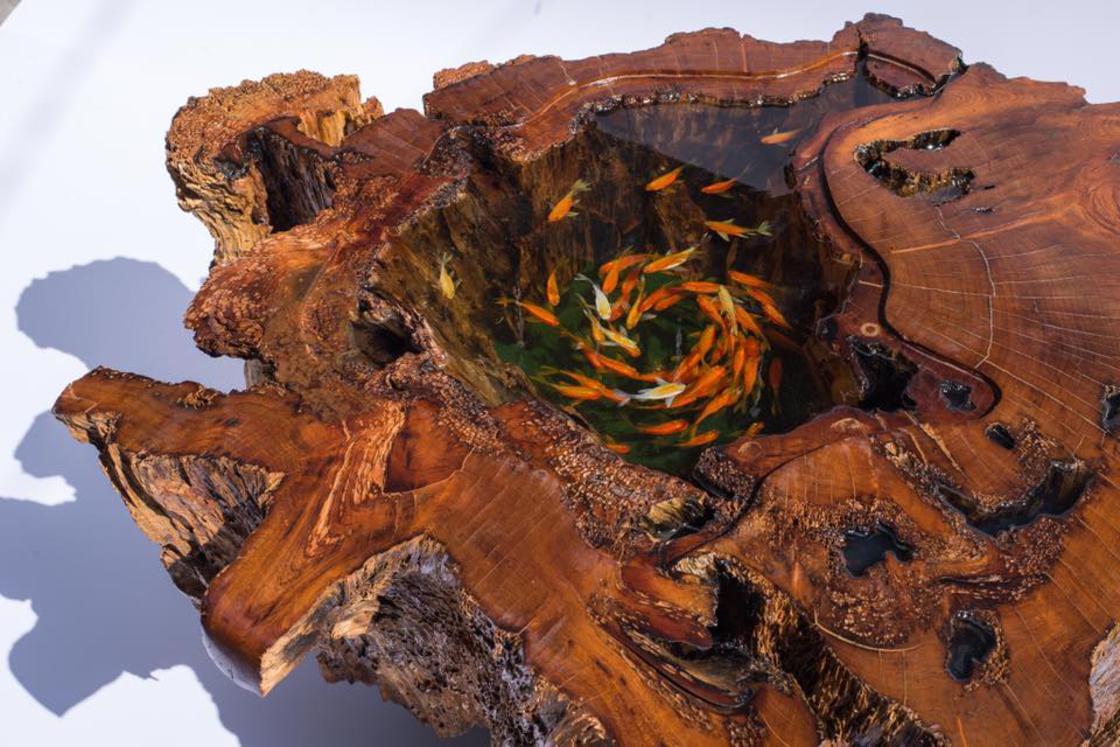 These amazing coffee tables create the illusion of a pond filled with fish