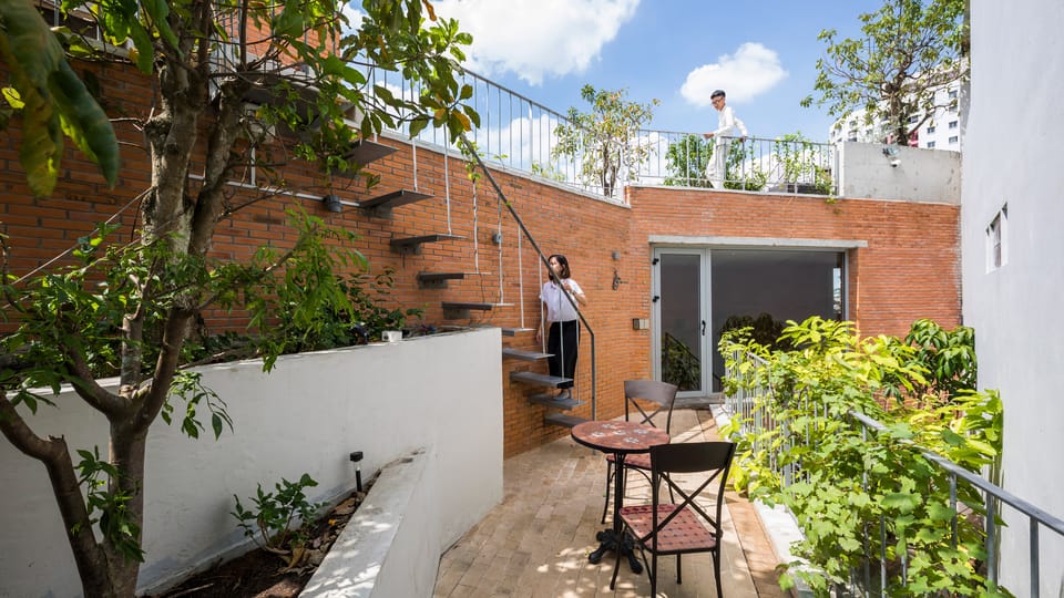 Garden terraces link living spaces in Ha House by Vo Trong Nghia Architects