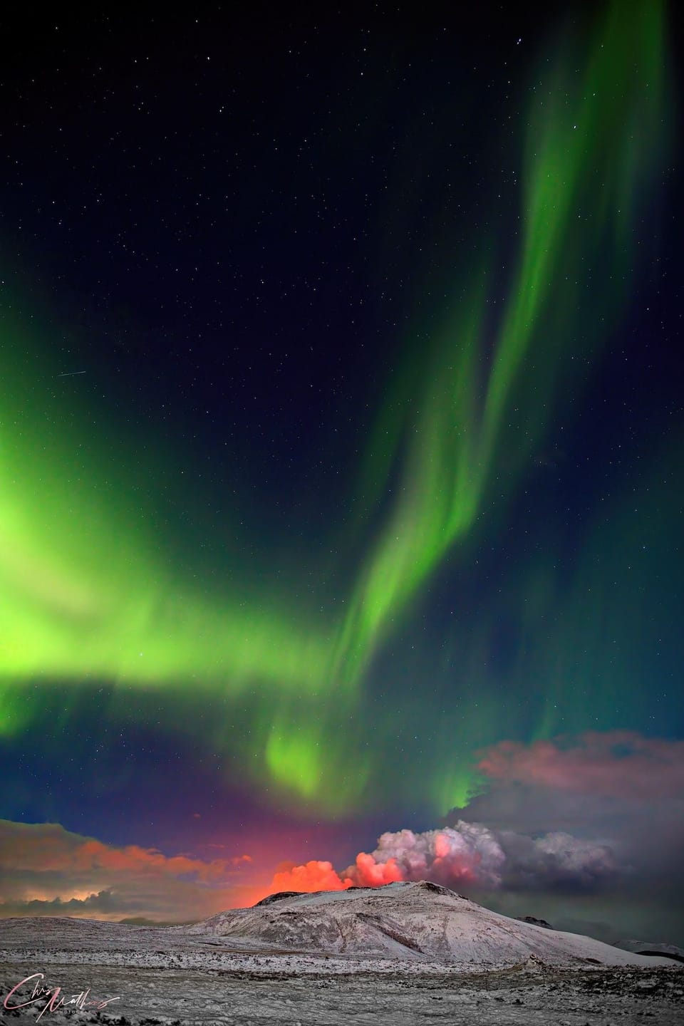 Photographer Captures Viral Shot of the Northern Lights Behind an Erupting Volcano